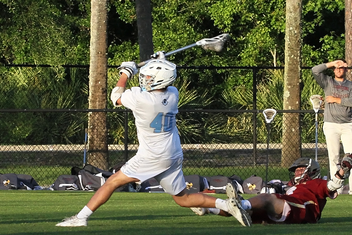 Ponte Vedra’s Dylan Hess knocks over a defender and attempts a shot in the Sharks’ 12-6 win over St. Augustine on Tuesday, May 1.